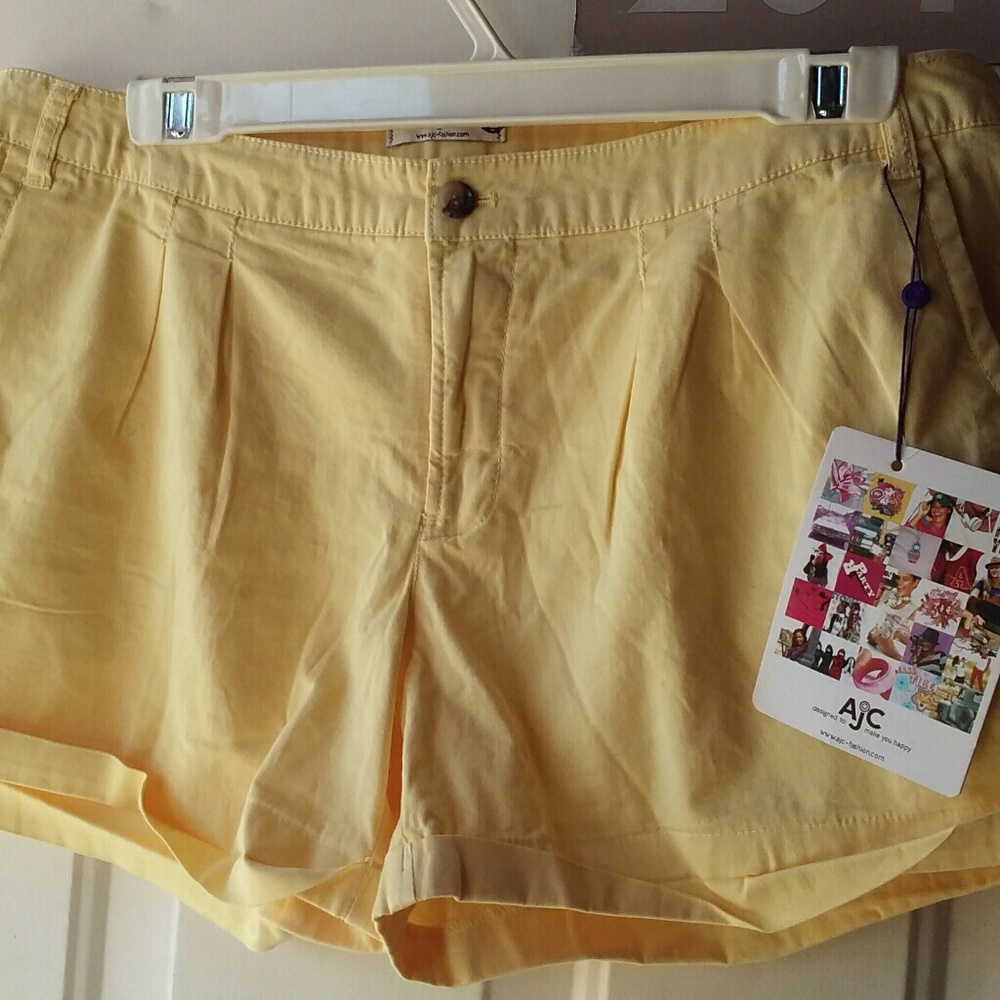 Ladies yellow shorts with buttons on back pockets